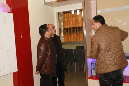 　四川新华电脑学院王助理向刘局长介绍环境艺术实训样板间